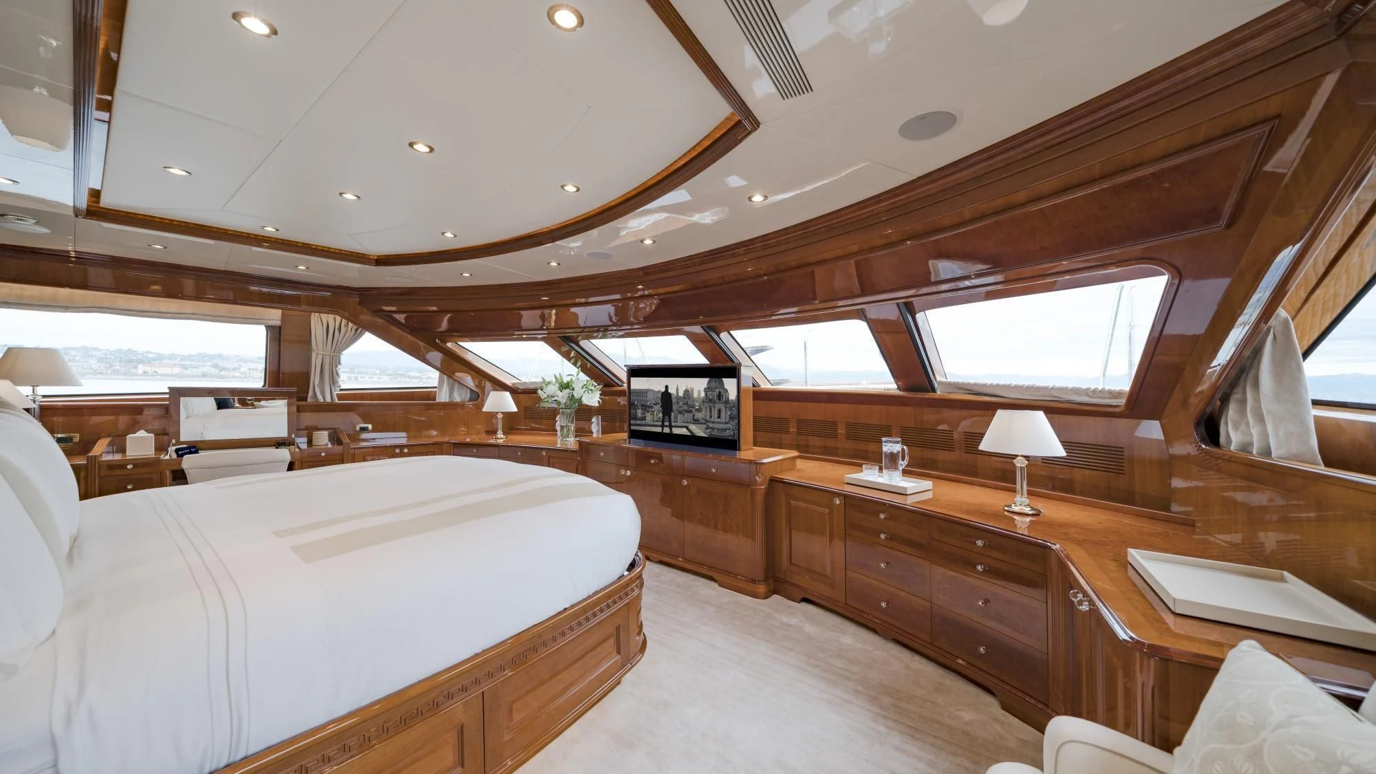 a room with a bed and a television aboard AURA Yacht for Sale