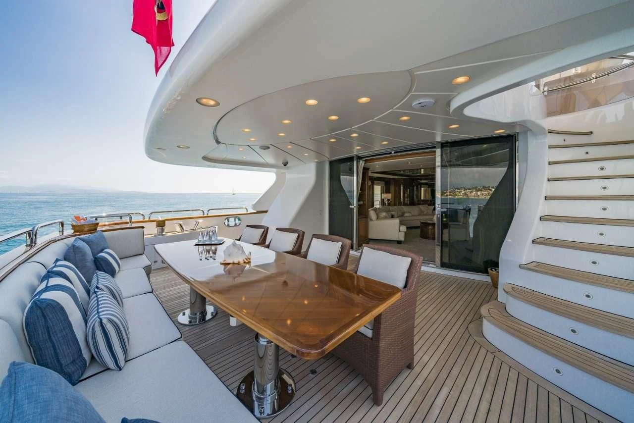a room with a table and chairs aboard AURA Yacht for Sale