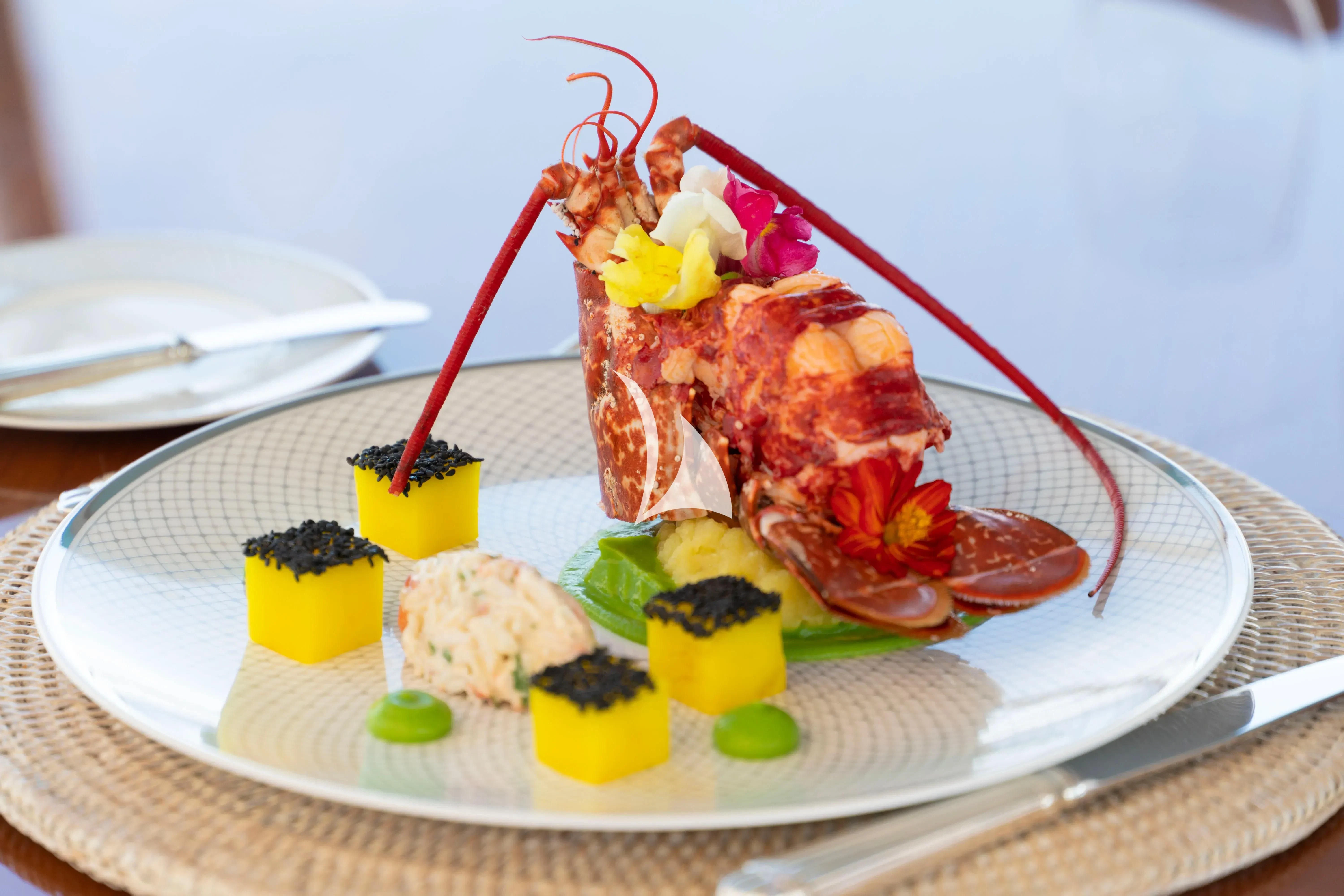 a plate of food aboard AURA Yacht for Sale