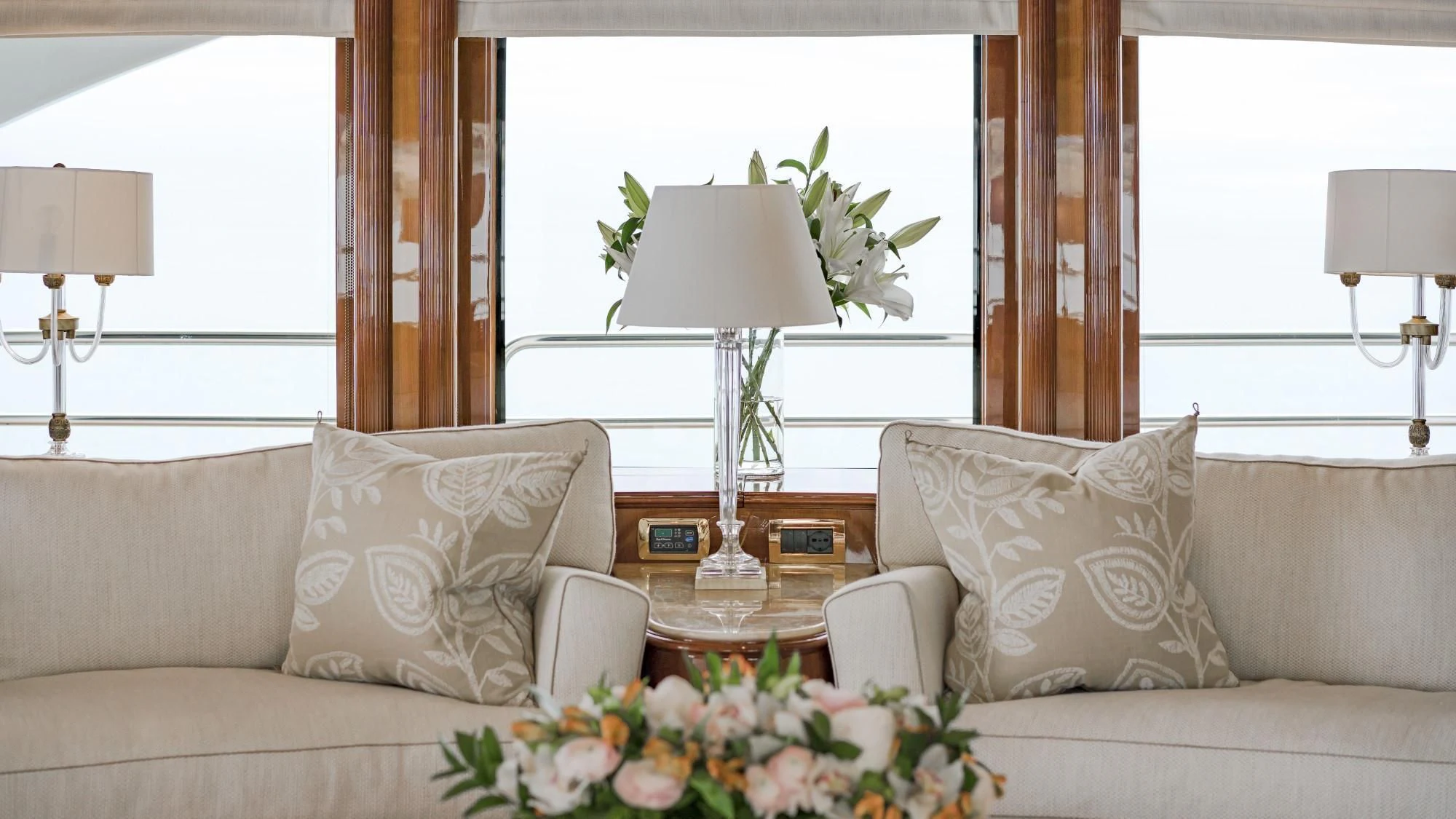 a living room with a couch and a table aboard AURA Yacht for Sale