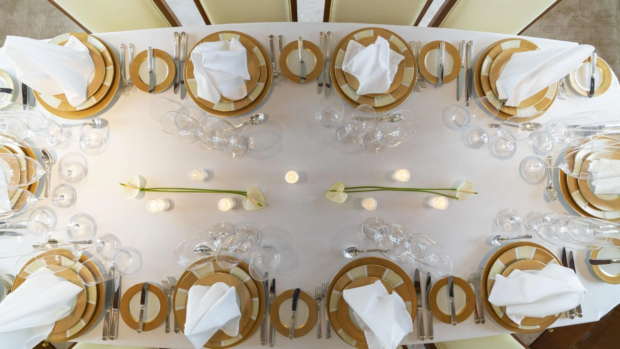 a table with many plates and glasses aboard AURA Yacht for Sale