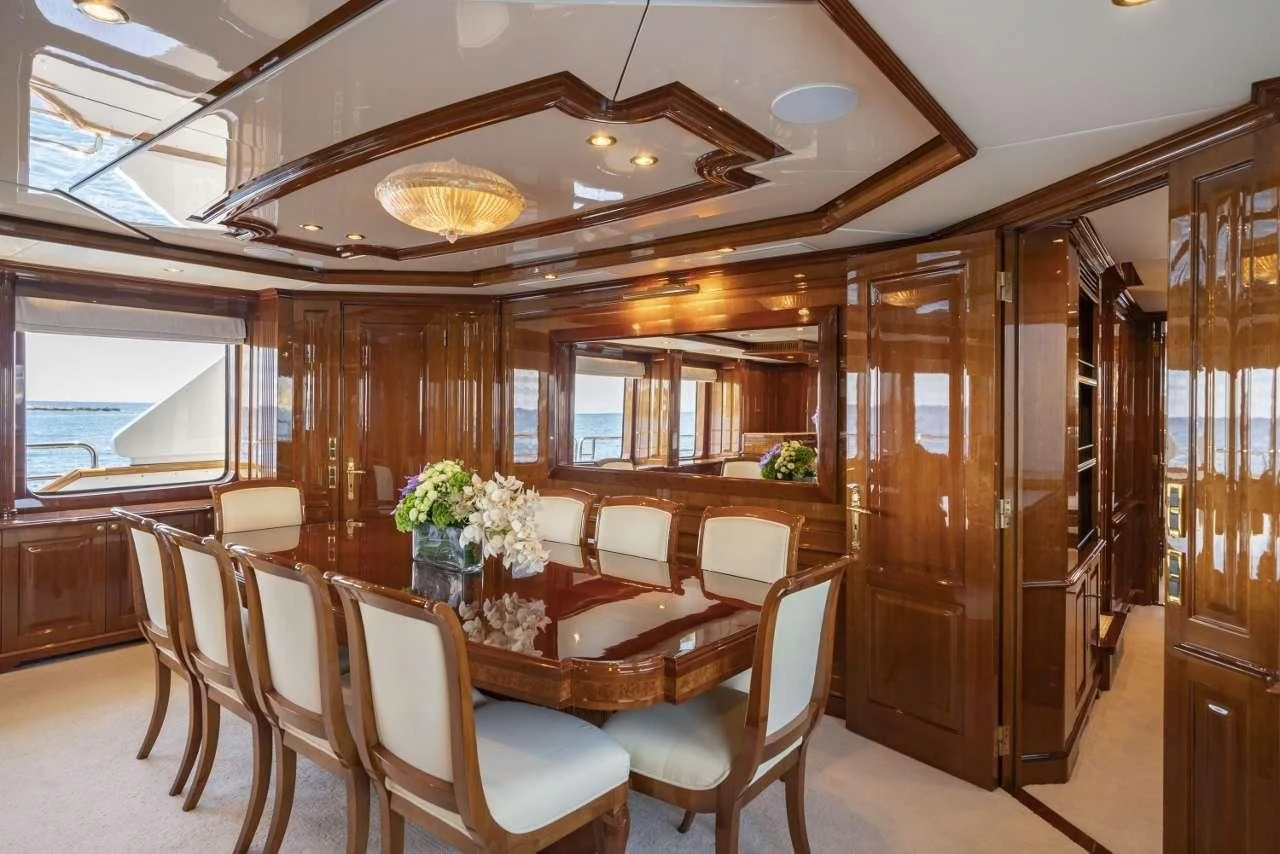 a dining room with a wood paneled ceiling aboard AURA Yacht for Sale