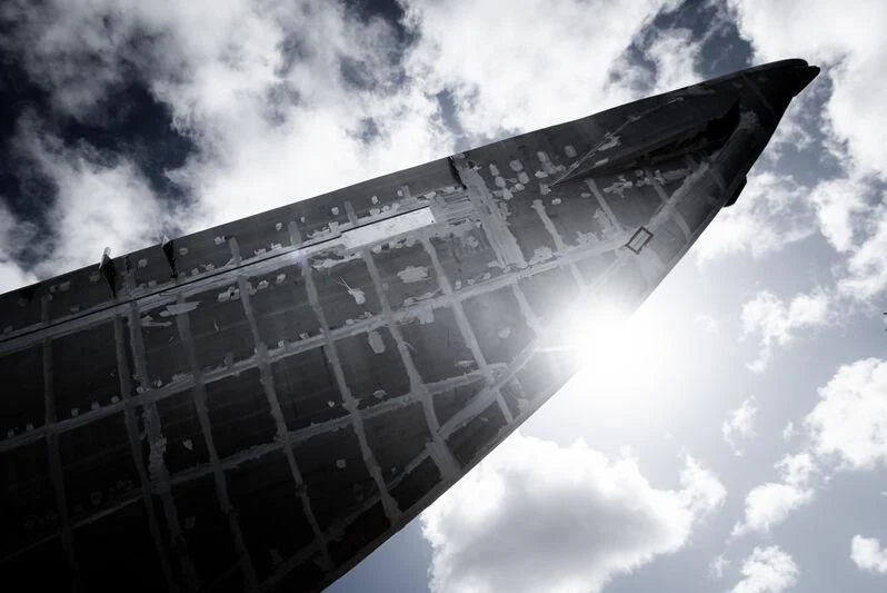 a tall building with a cloudy sky aboard AQUARIUS Yacht for Sale