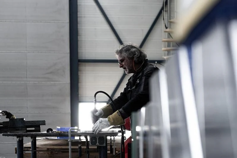 a person using a tool to cut a window aboard AQUARIUS Yacht for Sale