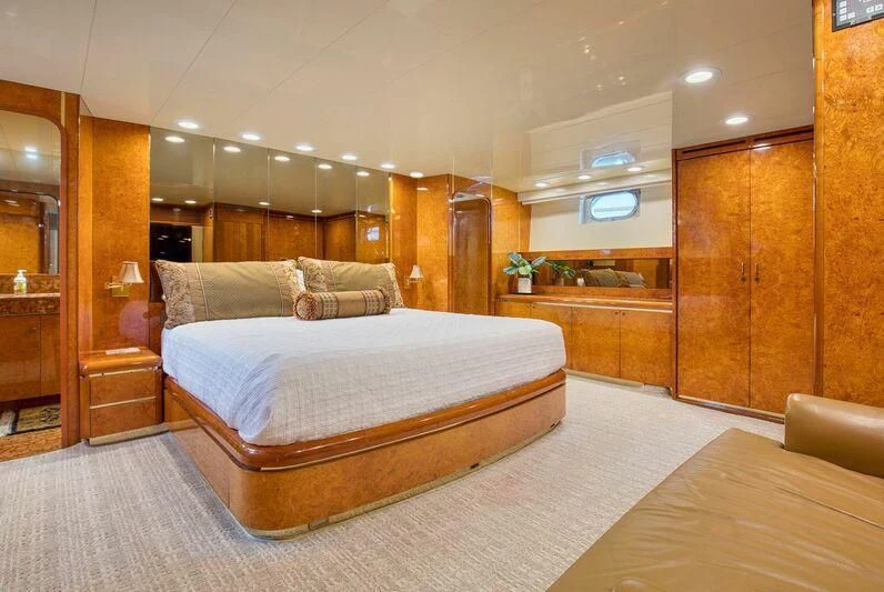 a bedroom with a bed and a desk aboard LE CANARD Yacht for Sale