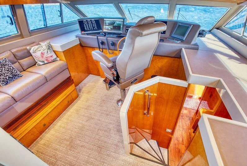 a room with a couch and a chair aboard LE CANARD Yacht for Sale