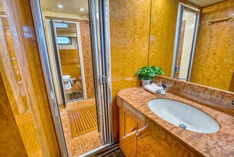 a bathroom with a sink and mirror aboard LE CANARD Yacht for Sale