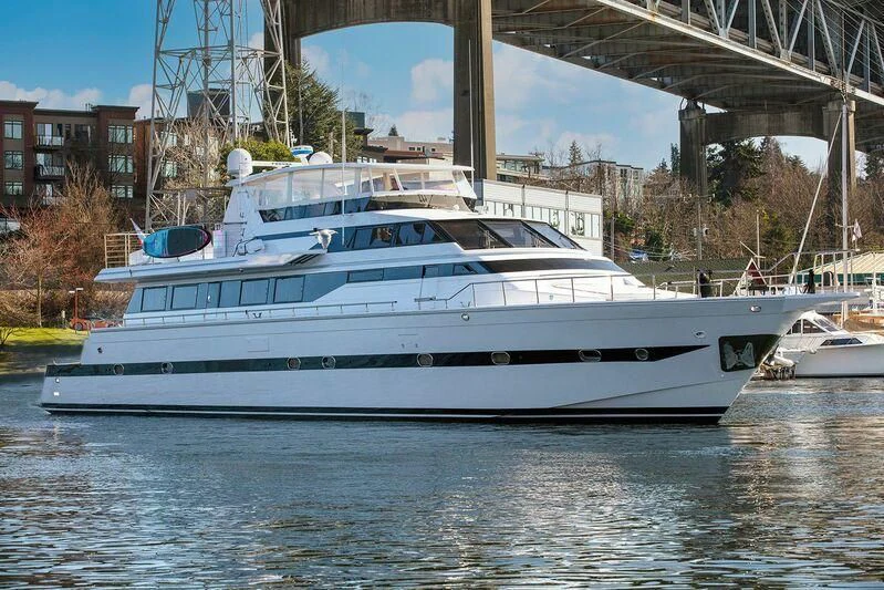 a large white boat in a harbor aboard LE CANARD Yacht for Sale