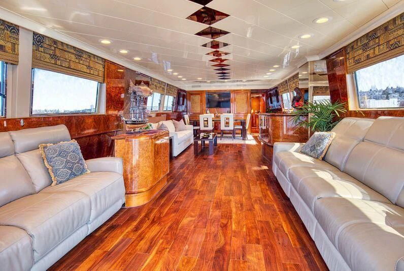 a living room with a wood floor aboard LE CANARD Yacht for Sale