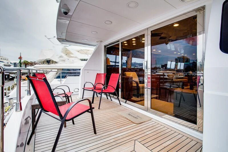 a boat with chairs and tables aboard LE CANARD Yacht for Sale