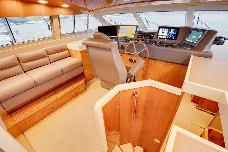 a room with a couch and a desk with computers on it aboard LE CANARD Yacht for Sale