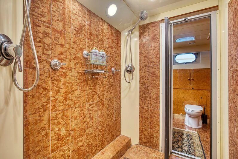a bathroom with a shower and toilet aboard LE CANARD Yacht for Sale