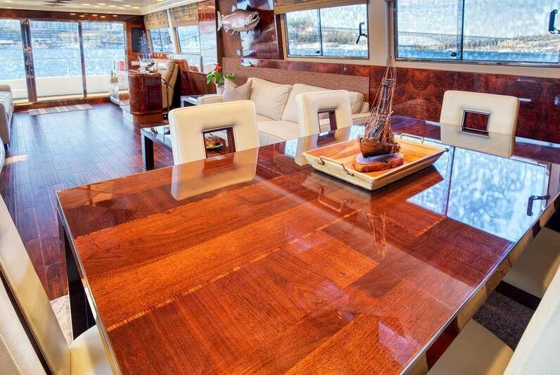 a living room with a wood floor aboard LE CANARD Yacht for Sale
