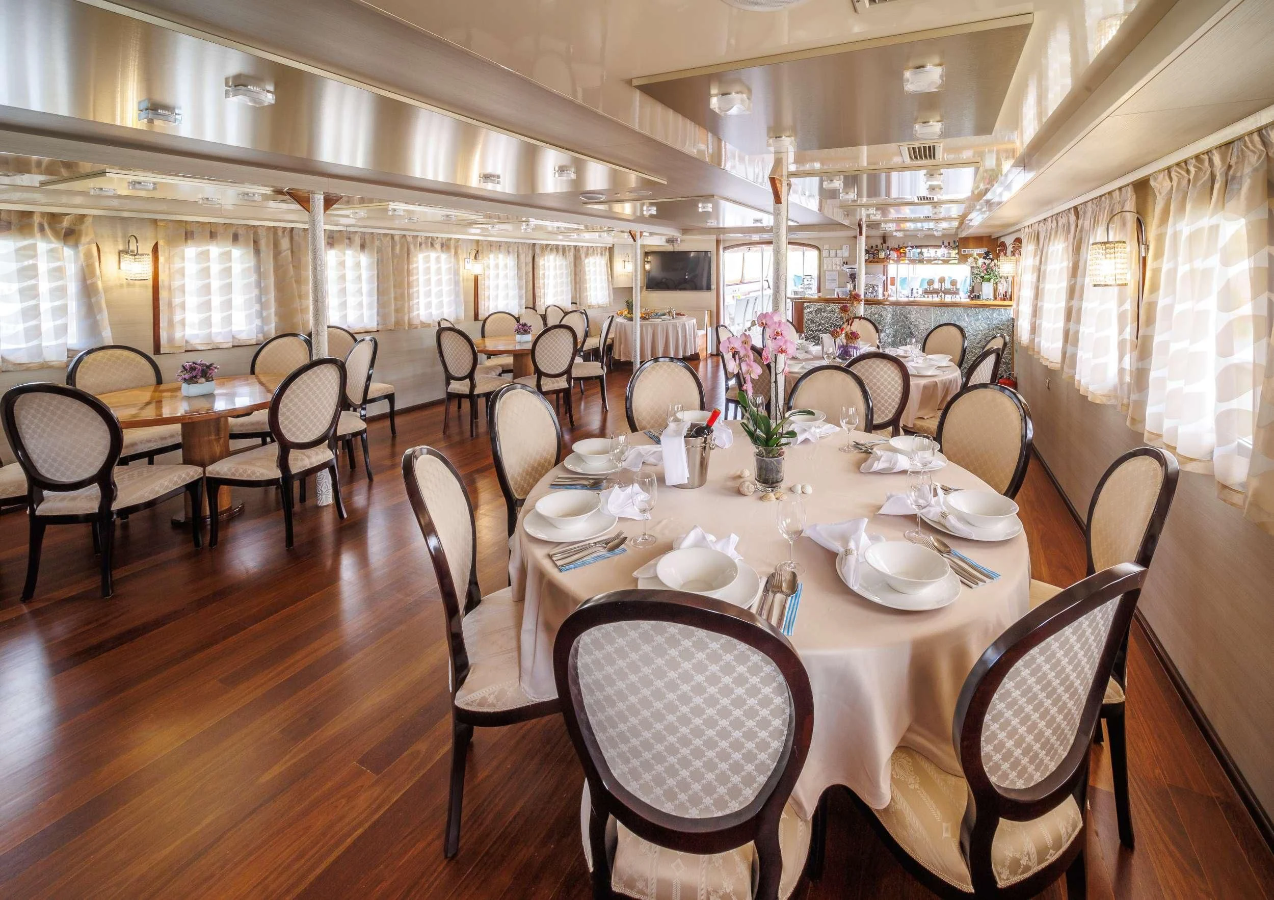 a dining room with tables and chairs aboard CASABLANCA Yacht for Sale