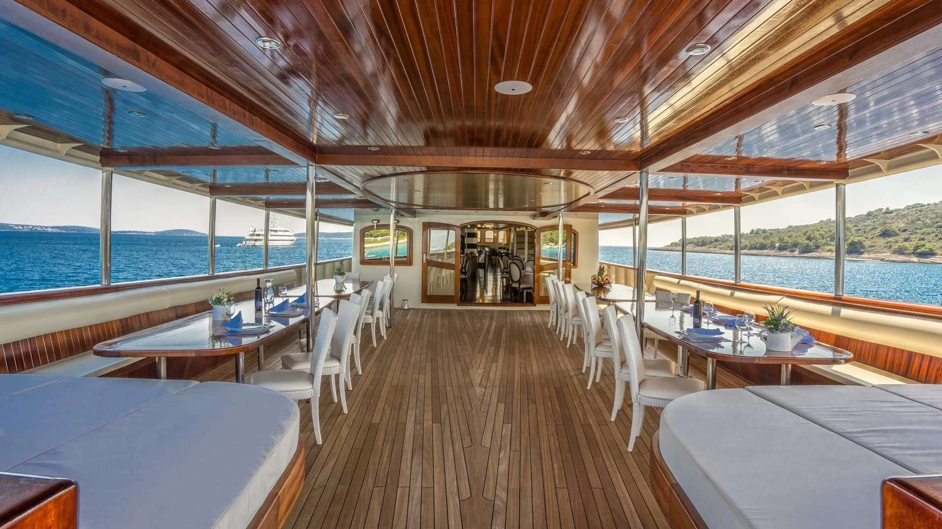 a room with tables and chairs aboard CASABLANCA Yacht for Sale