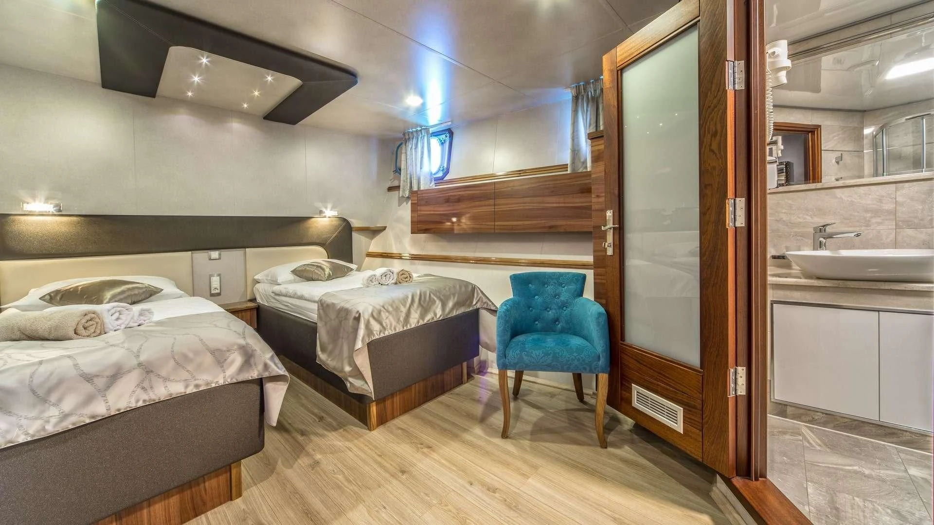 a room with two beds and a sink aboard CASABLANCA Yacht for Sale