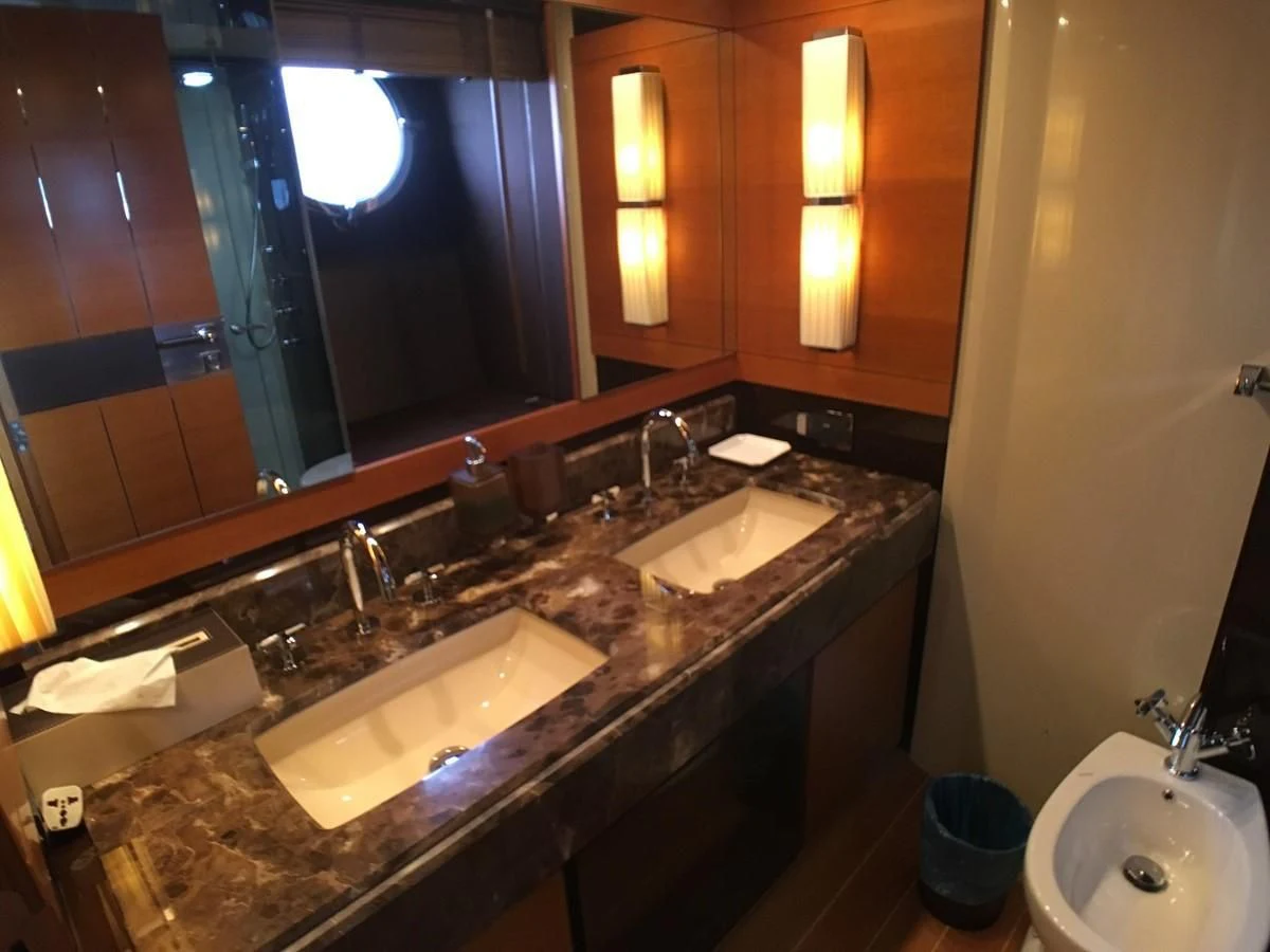 a bathroom with sinks and mirrors aboard AZIMUT 75 Yacht for Sale
