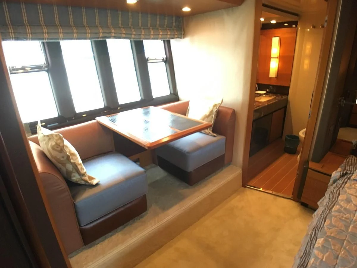 a living room with a couch and a table aboard AZIMUT 75 Yacht for Sale