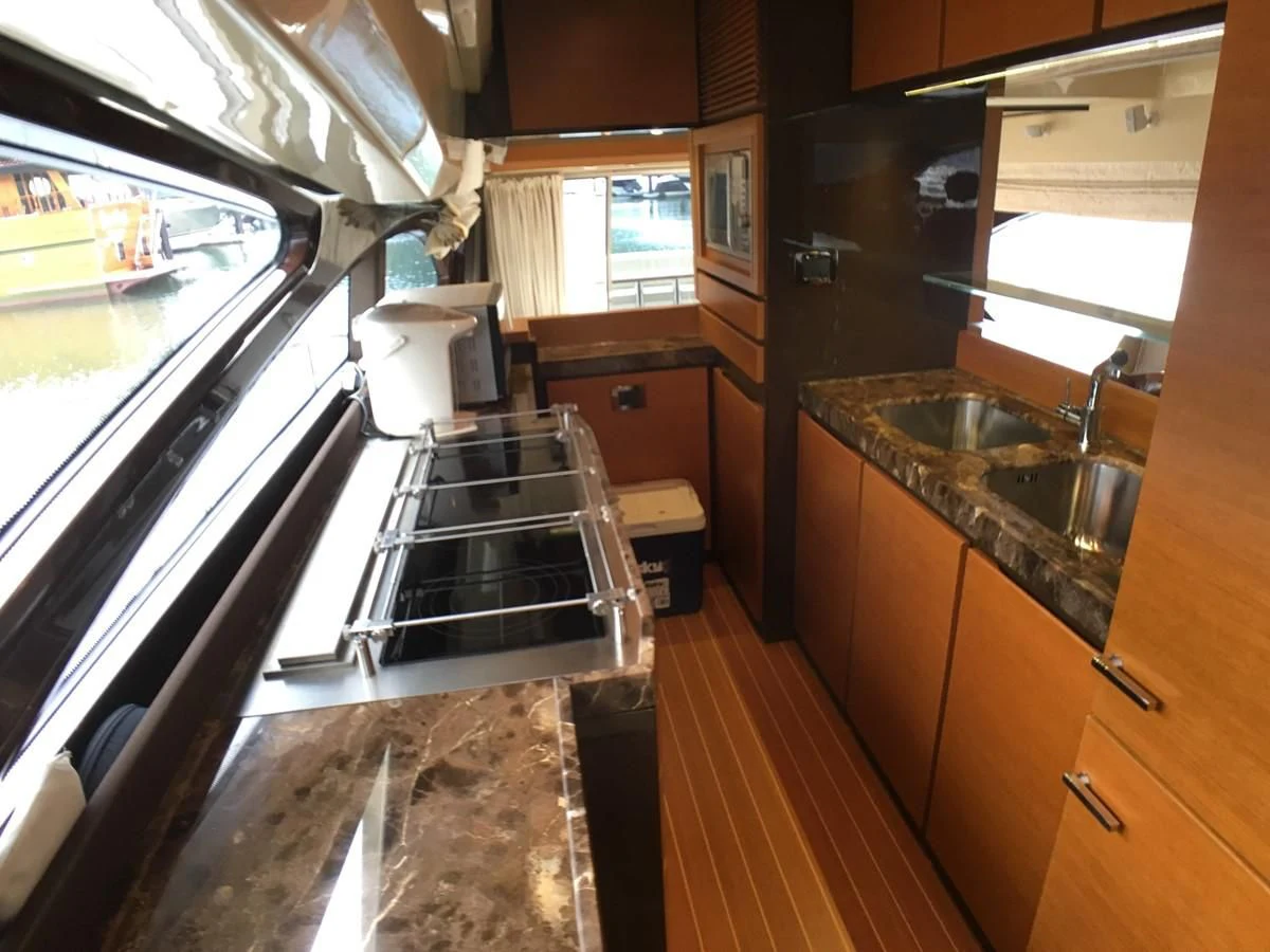 a kitchen with a sink and stove aboard AZIMUT 75 Yacht for Sale