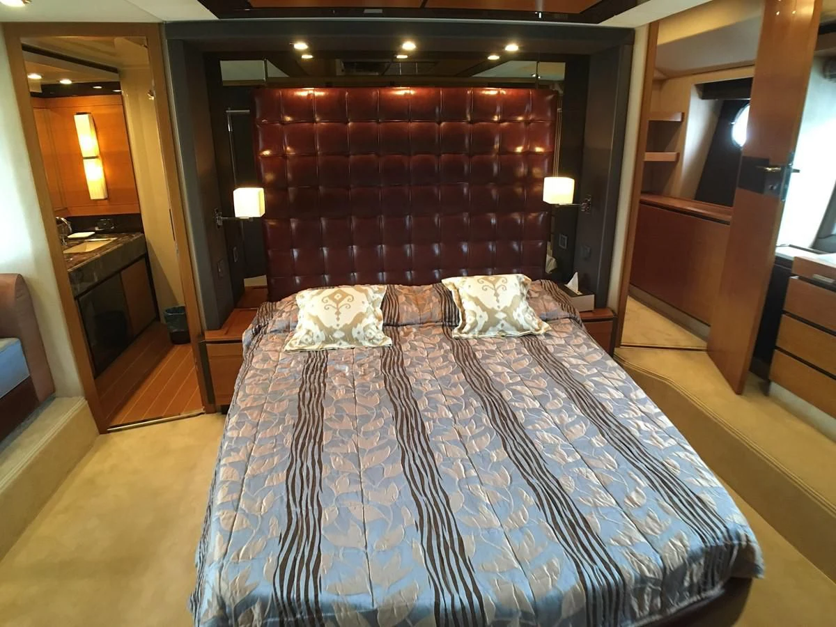 a bed with a blue sheet aboard AZIMUT 75 Yacht for Sale