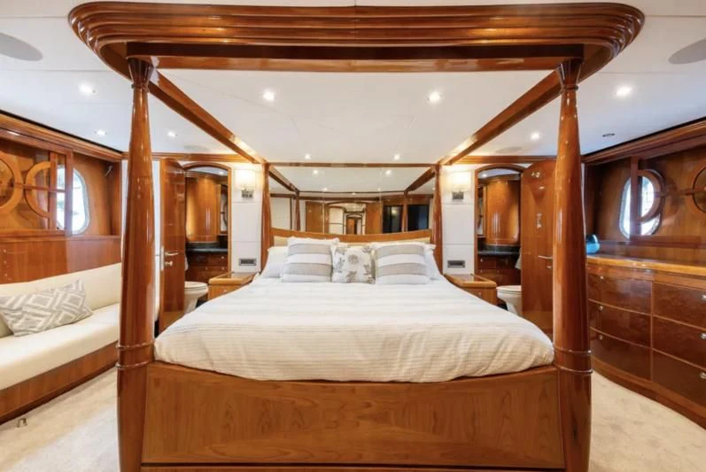 a room with a bed and a wood wall aboard OCEANS I Yacht for Sale