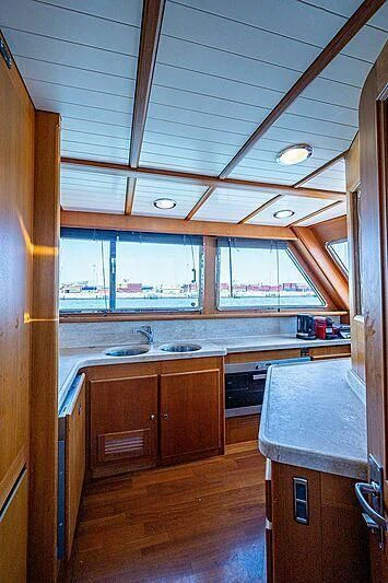 a kitchen with a large window aboard CABALLERO Yacht for Sale