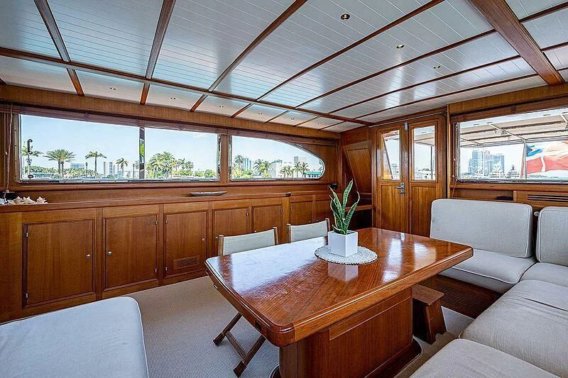 a room with a table and chairs aboard CABALLERO Yacht for Sale