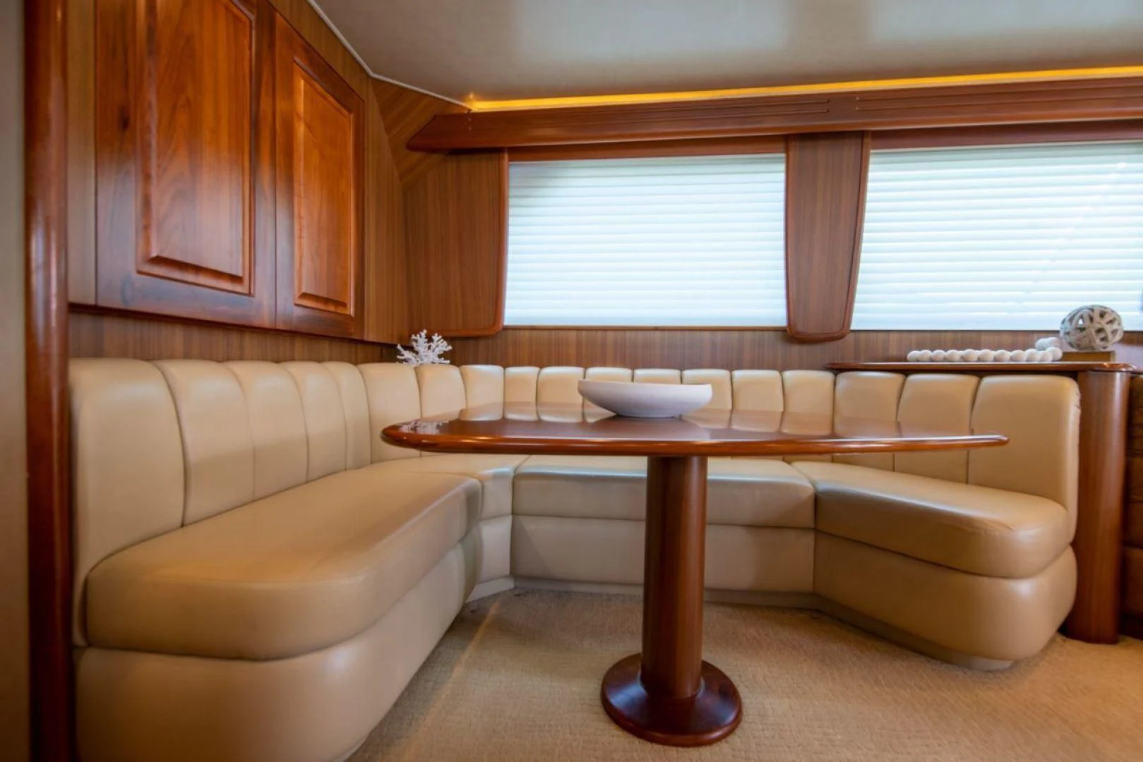 a room with a table and couch aboard SALT7 Yacht for Sale