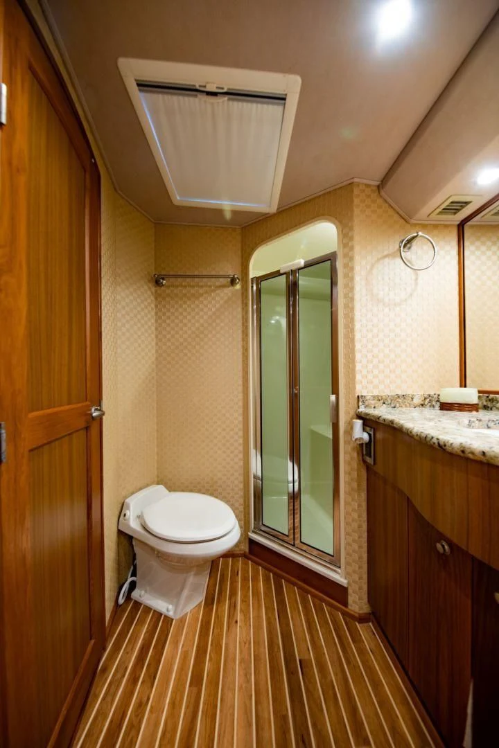 a bathroom with a glass shower door aboard SALT7 Yacht for Sale
