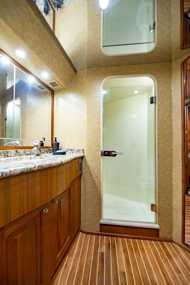a bathroom with a glass door aboard SALT7 Yacht for Sale