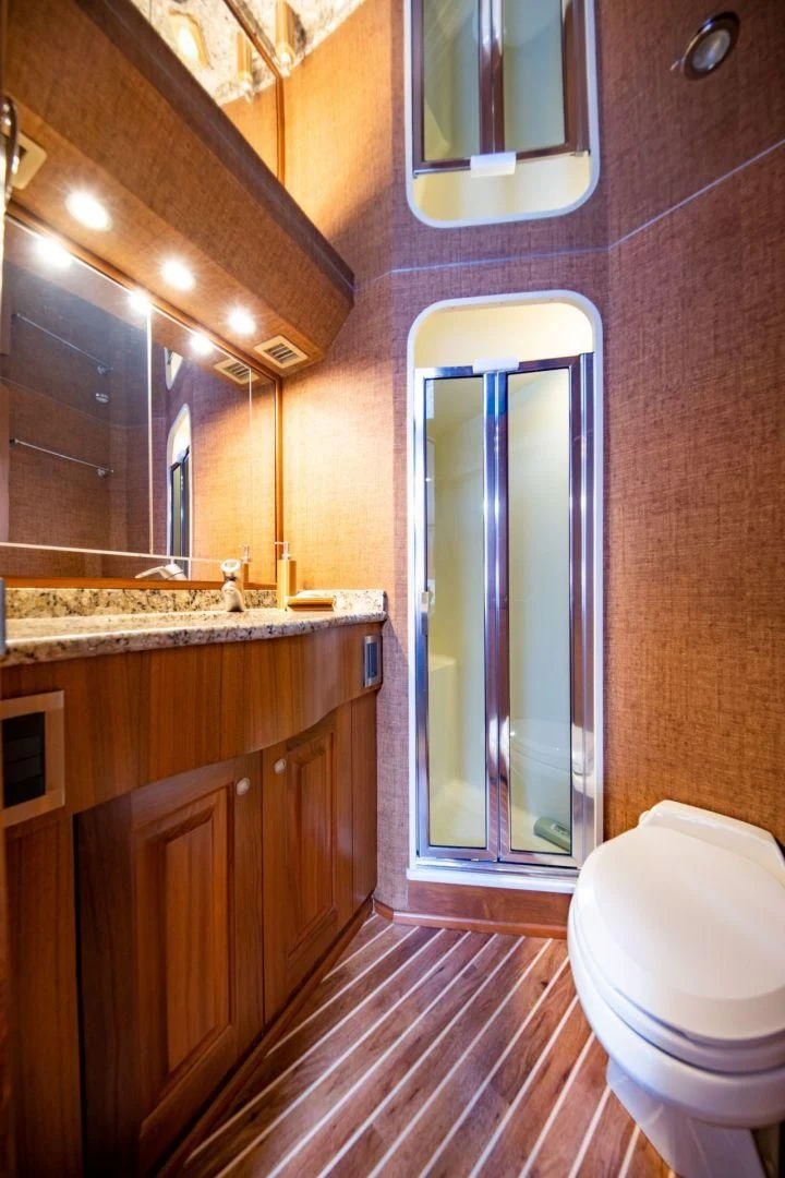a bathroom with a glass shower door aboard SALT7 Yacht for Sale