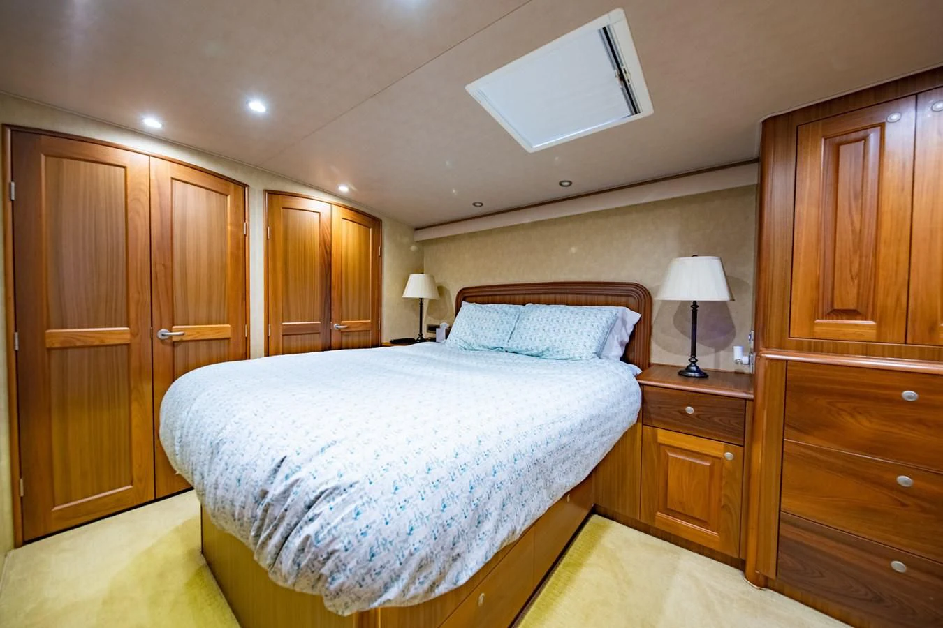 a bedroom with a bed and cabinets aboard SALT7 Yacht for Sale
