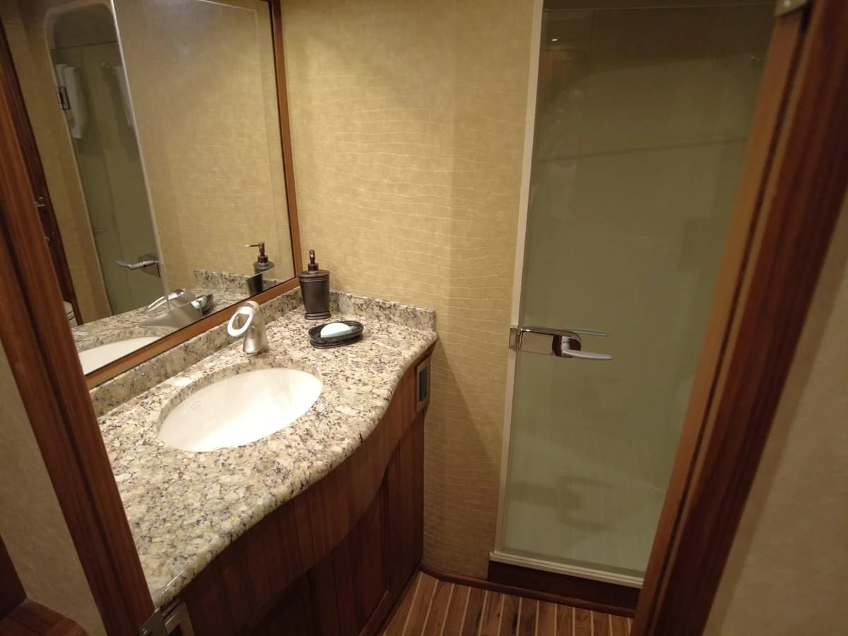 a bathroom with a sink and a mirror aboard SALT7 Yacht for Sale