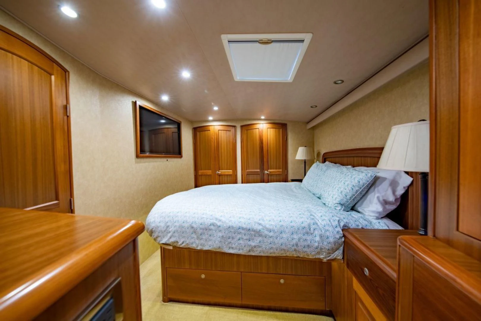 a bedroom with a bed and a desk aboard SALT7 Yacht for Sale