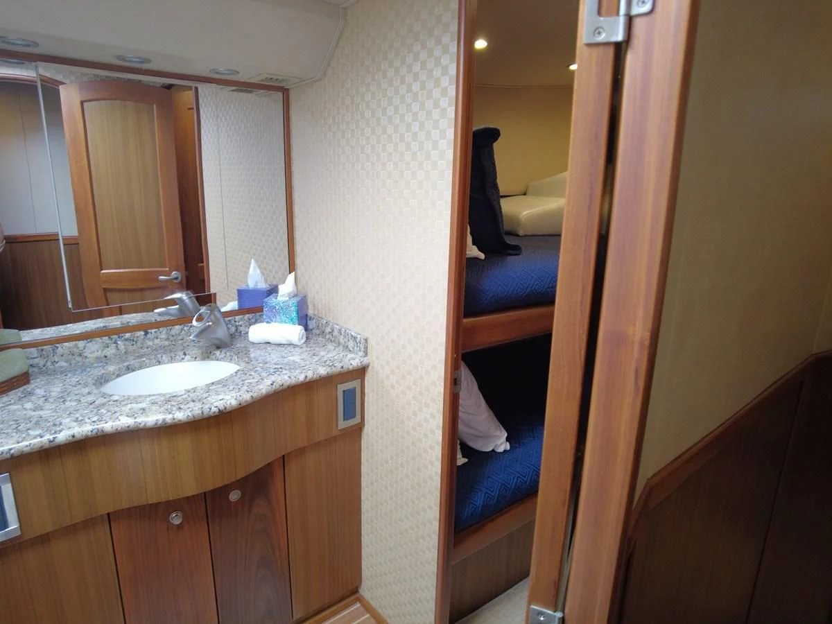 a bathroom with a sink and a mirror aboard SALT7 Yacht for Sale
