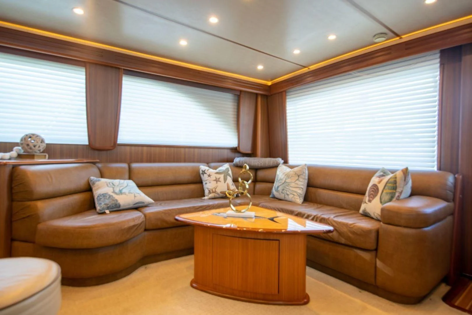 a living room with a couch and coffee table aboard SALT7 Yacht for Sale