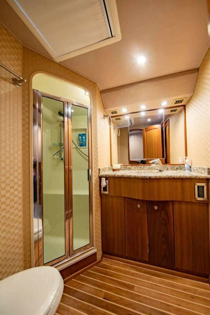 a bathroom with a glass shower door aboard SALT7 Yacht for Sale