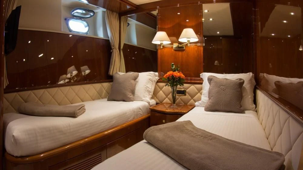 a room with a bed and a couch aboard CRISTALES Yacht for Sale