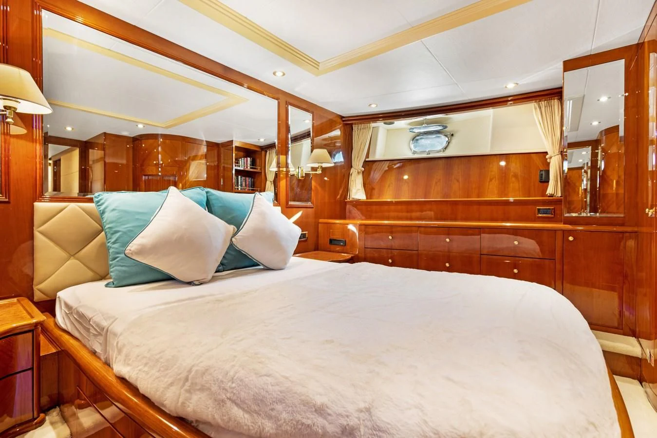 a bed with a white sheet and pillows aboard CRISTALES Yacht for Sale