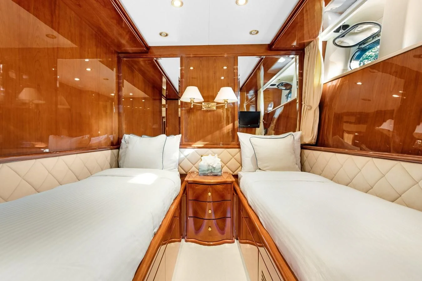 a room with a bed and a mirror aboard CRISTALES Yacht for Sale