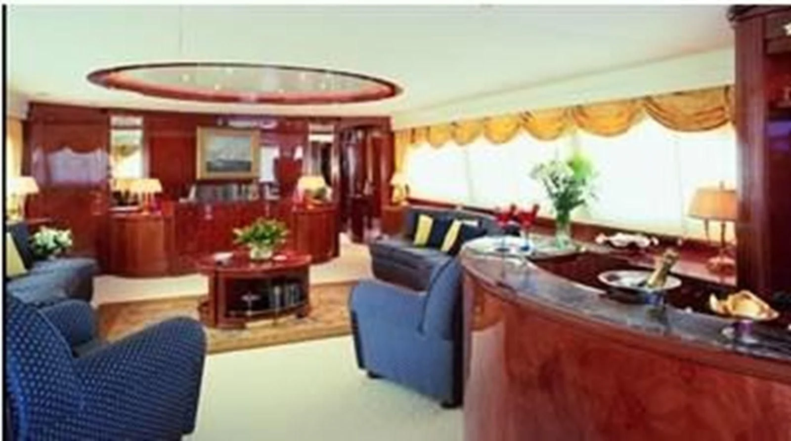 a living room with a table and chairs aboard CRISTALES Yacht for Sale