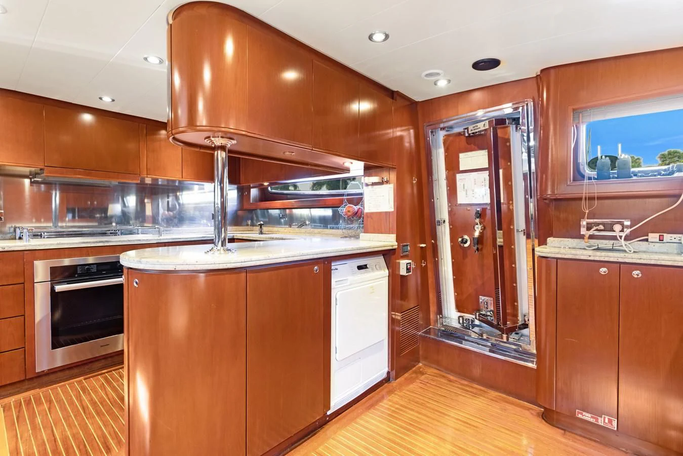 a kitchen with wooden cabinets aboard CRISTALES Yacht for Sale