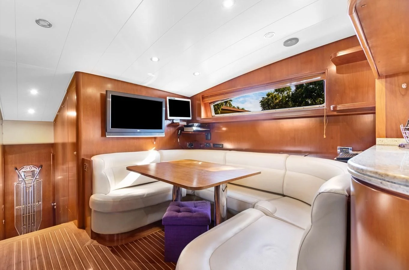 a room with a table and couch aboard CRISTALES Yacht for Sale
