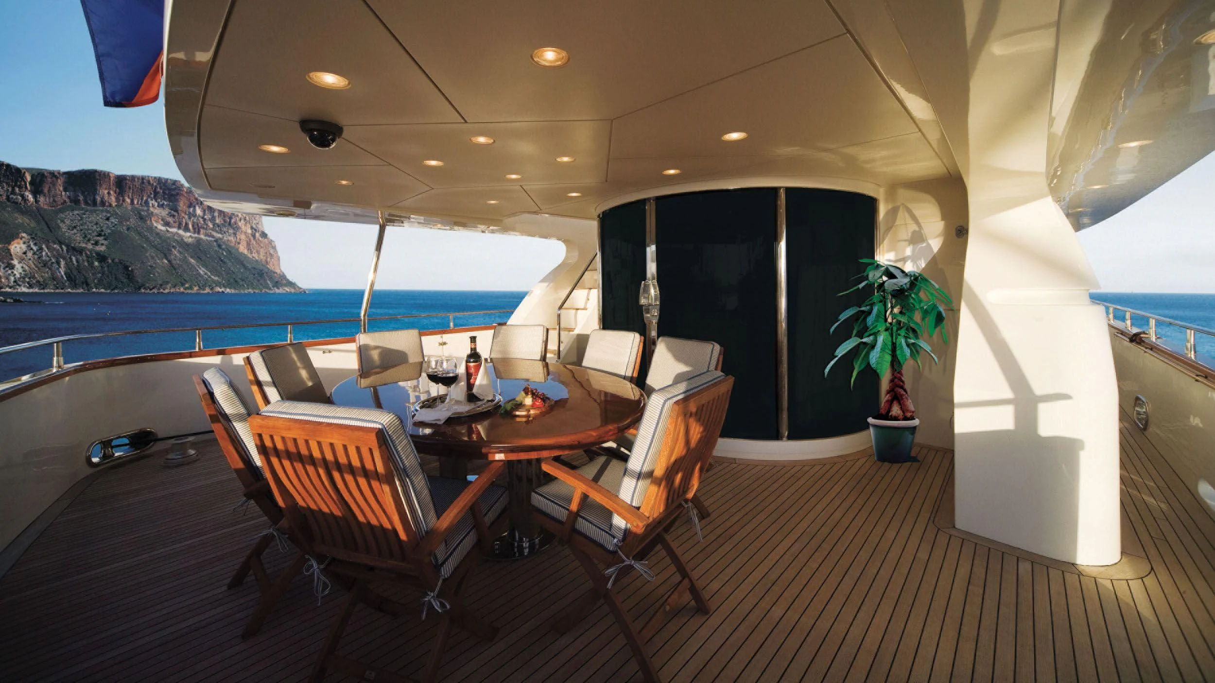 a room with a table chairs and a large window with a view of the ocean aboard CRISTALES Yacht for Sale