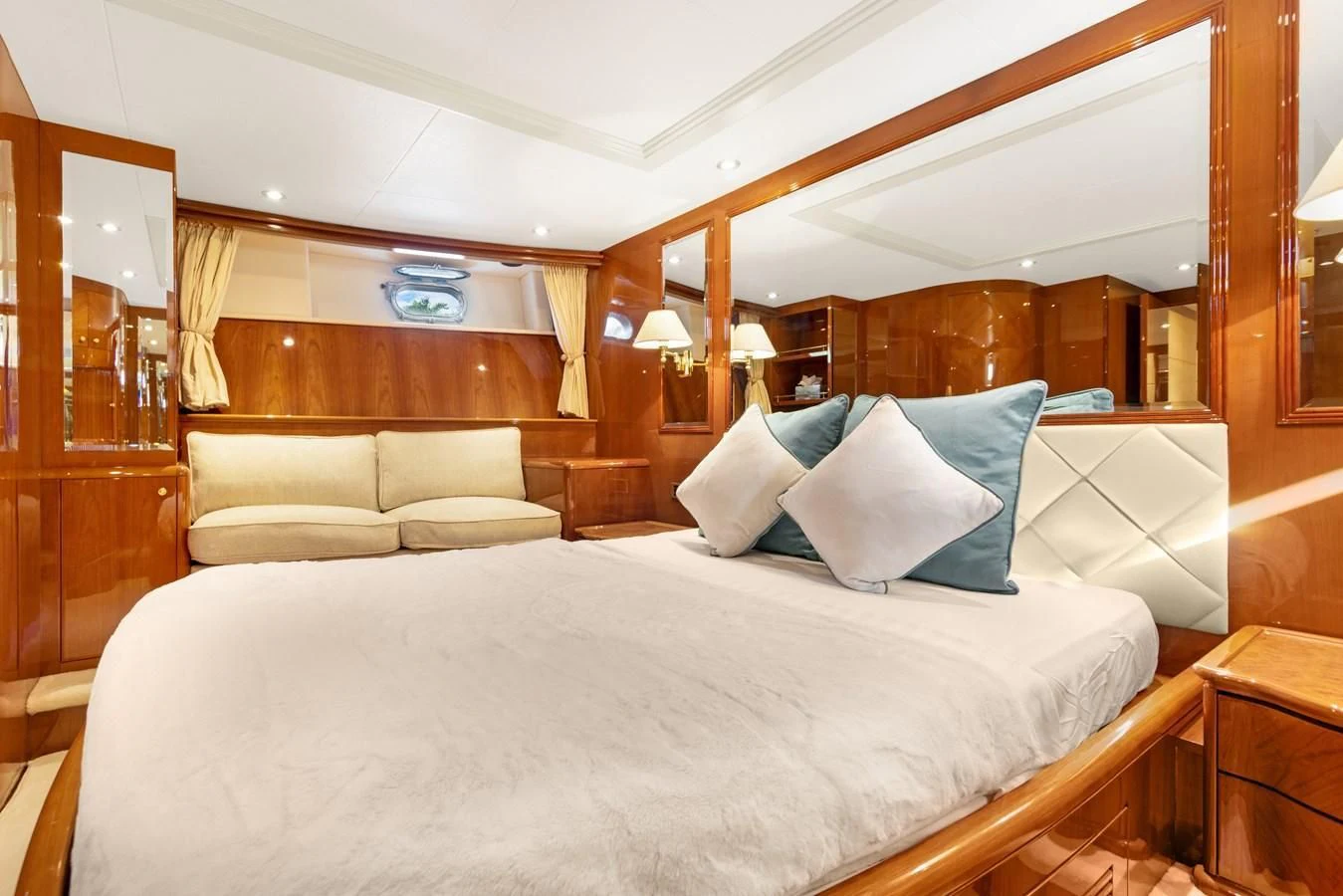 a bed with a white sheet and pillows aboard CRISTALES Yacht for Sale