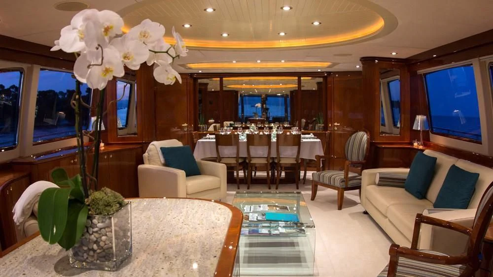a room with a table chairs and a television aboard CRISTALES Yacht for Sale