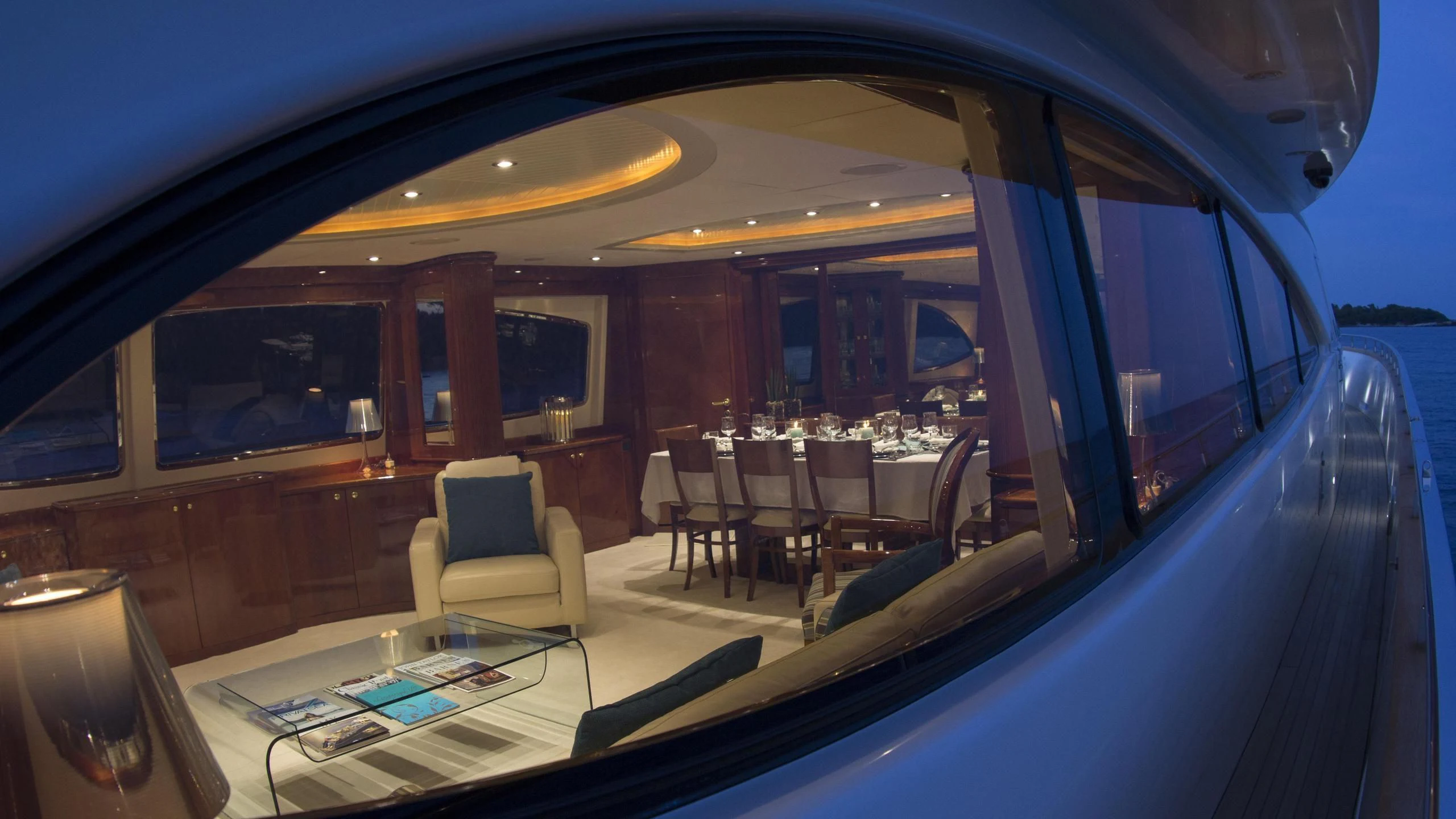 inside of a vehicle with a table and chairs and a tv on the wall aboard CRISTALES Yacht for Sale