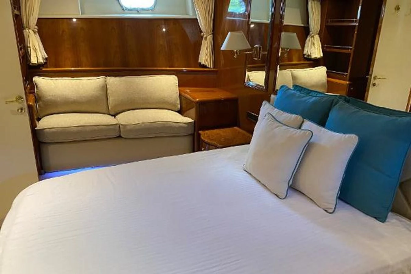 a room with a couch and a bed aboard CRISTALES Yacht for Sale