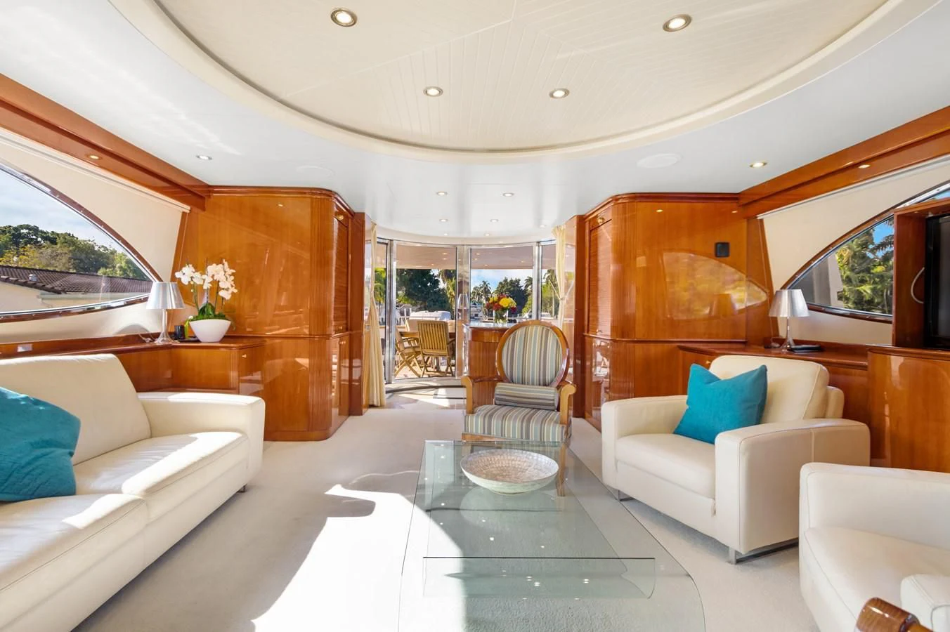 a living room with a glass table aboard CRISTALES Yacht for Sale