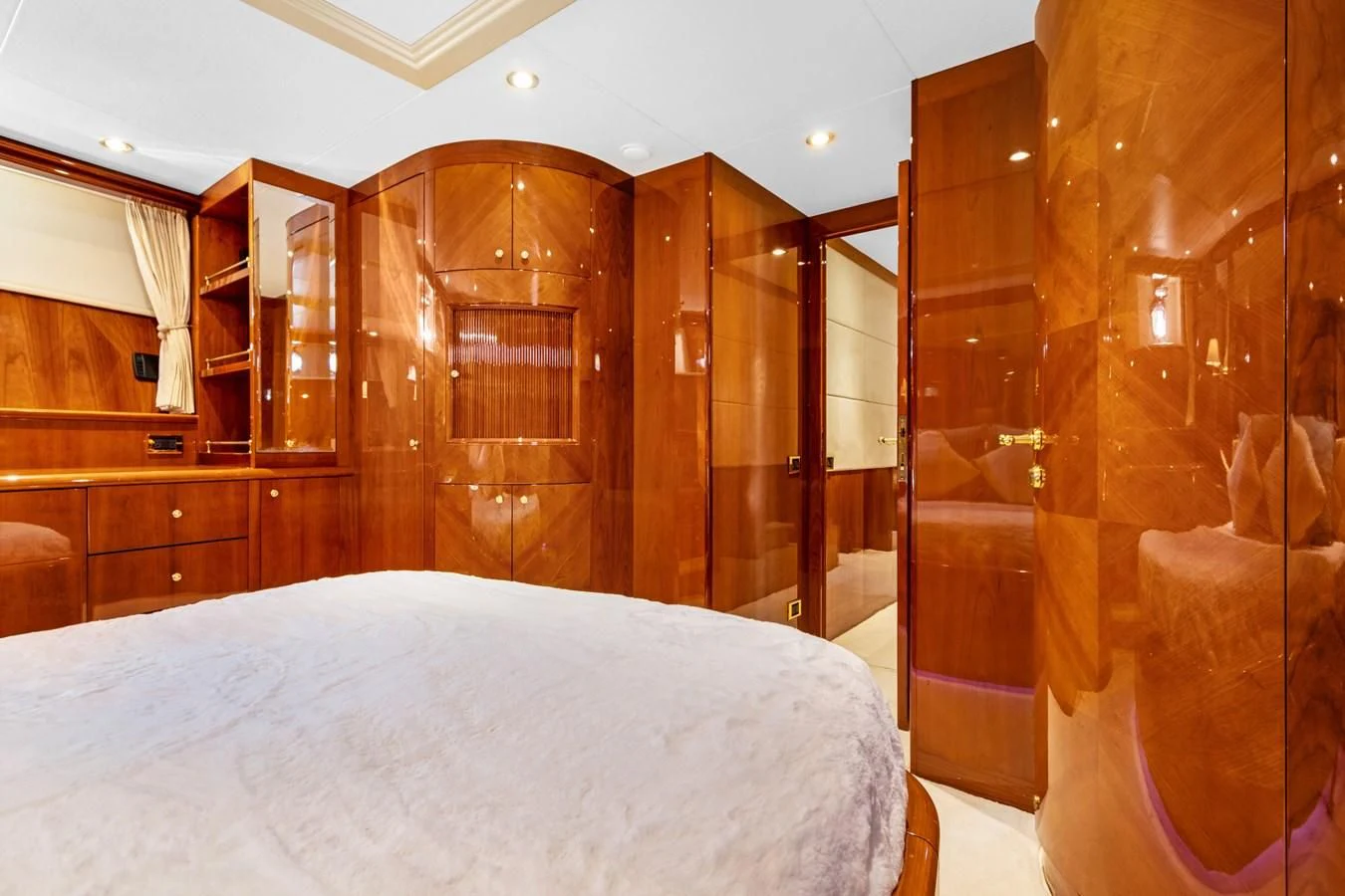 a bedroom with a bed and a closet aboard CRISTALES Yacht for Sale